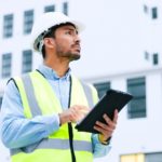 Male,Engineer,Checking,Data,On,Digital,Tablet,And,Inspecting,Construction