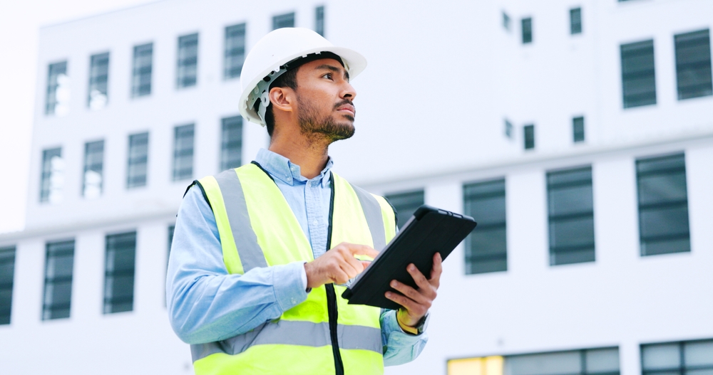 Male,Engineer,Checking,Data,On,Digital,Tablet,And,Inspecting,Construction