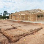 New,Residential,Construction,Home,Framing,Against,A,Blue,Sky.
